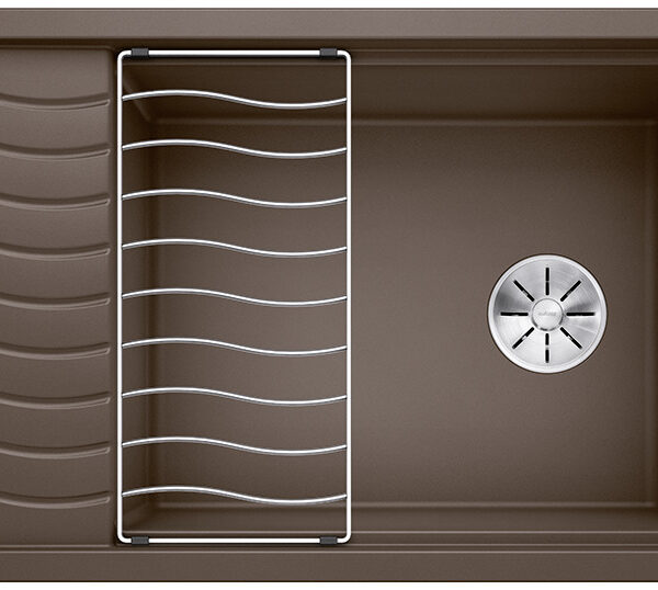 Brown kitchen sink with a metal wire dish rack over the left side and a drain in the right basin.