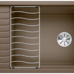 Brown rectangular kitchen sink with a left wave-patterned drainboard, a metal dish rack in the center, and a round drain on the right side.