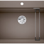 Brown rectangular kitchen sink viewed from above with a circular silver drain centered, and two metal rack rods along the right side.