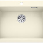 Beige rectangular kitchen sink viewed from above, empty with a circular metal drain in the center.