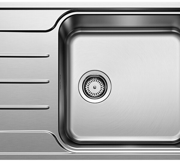 Stainless steel kitchen sink with an integrated draining board on the left side.