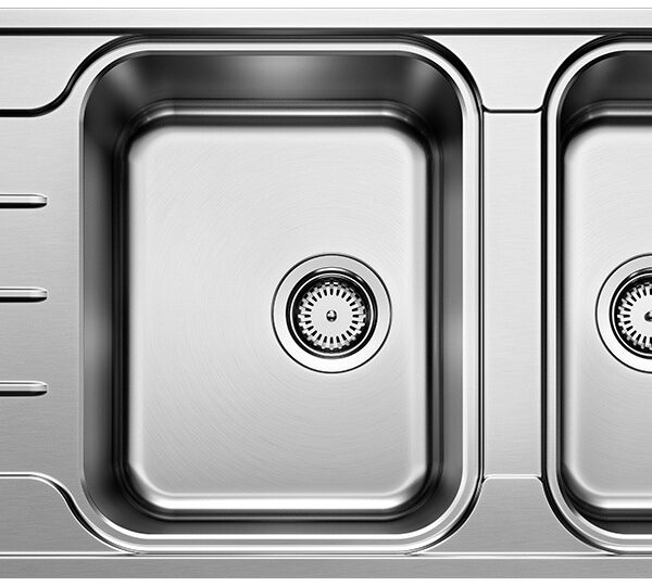 Stainless steel double kitchen sink with a built-in left draining rack and grooves on the counter side.