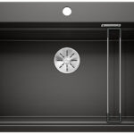 Black rectangular kitchen sink with a stainless drain and a chrome drying rack on the right side.