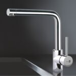 Chrome kitchen faucet with a tall curved spout and single lever handle on a reflective surface.