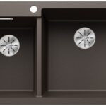 Brown double kitchen sink with two basins and circular chrome drain covers.