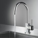 Chrome gooseneck kitchen faucet with water running into a stainless sink.