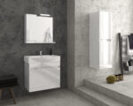 Modern bathroom with a white vanity, mirror cabinet and towel hanging against dark textured walls.