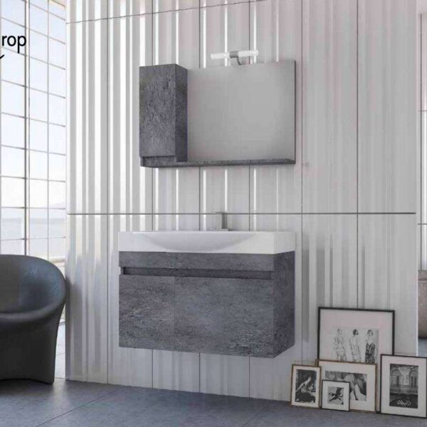 Modern bathroom with a floating grey stone vanity, matching wall cabinet, and a curved gray chair beside framed art on the floor along a vertical-panel wall.