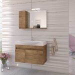 Modern bathroom with a wood vanity, wall mirror, and beige towel; a pink lounge chair sits in the corner.