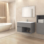 Modern bathroom with a freestanding white tub, beige tiled walls, and a grey vanity with an open shelf of towels on the right.