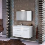 Modern bathroom vanity with a wall-mounted cabinet and horizontal bar light against textured mosaic walls and wood slat panels on either side.