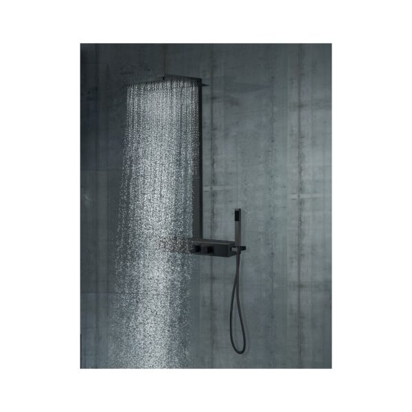 Wide shower with a rectangular rainfall head pouring water against a dark concrete wall.