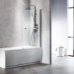 Modern bathroom with a white bathtub and curved glass shower screen, featuring a rain shower and handheld wand in a minimalist setting.